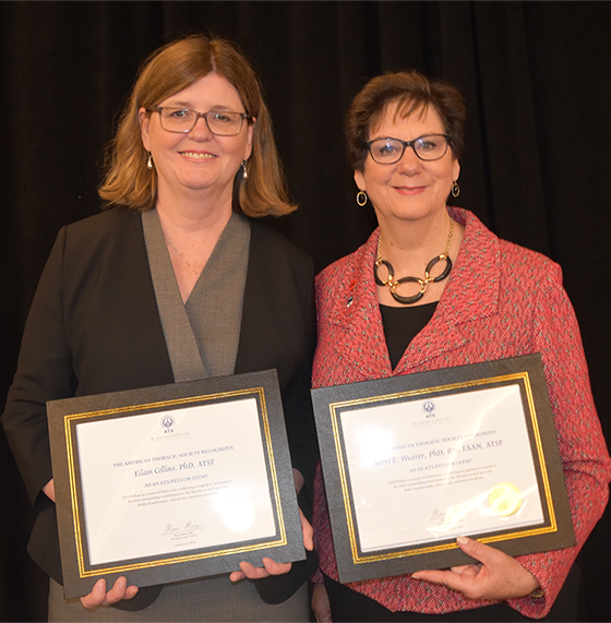 Eileen Collins and Terri Weaver posing with certificates of fellowship