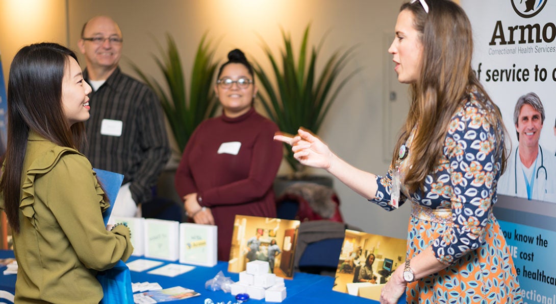 student and recruiter at job fair