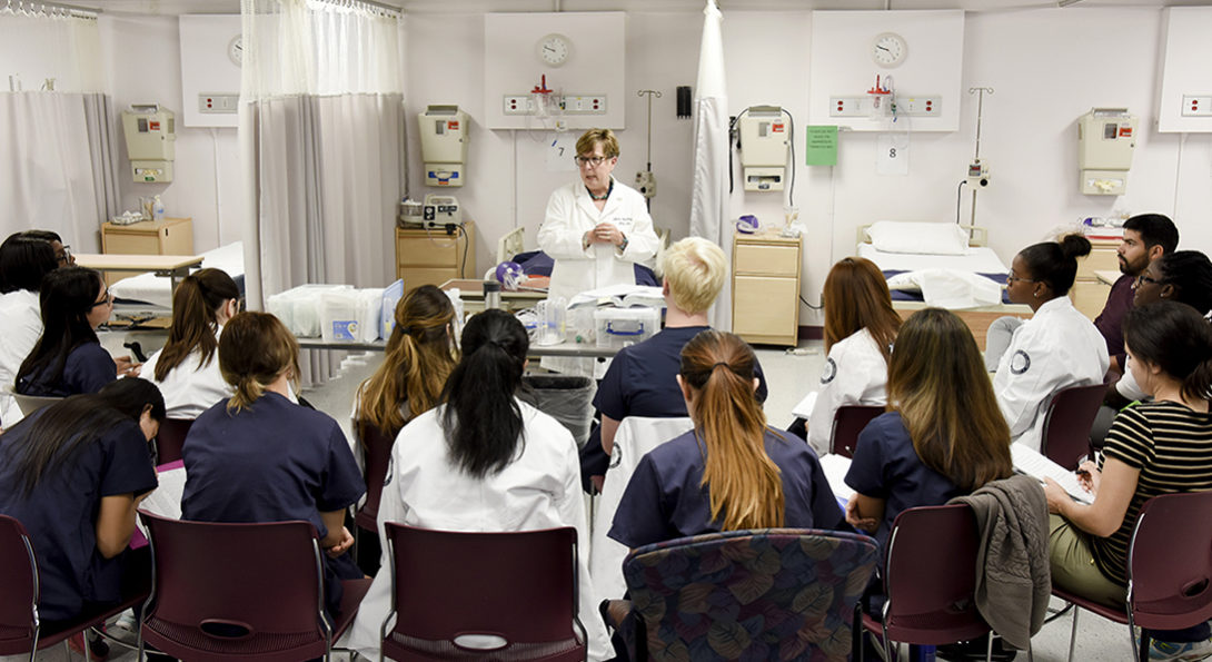 Teacher standing in front of students in clinical classroom