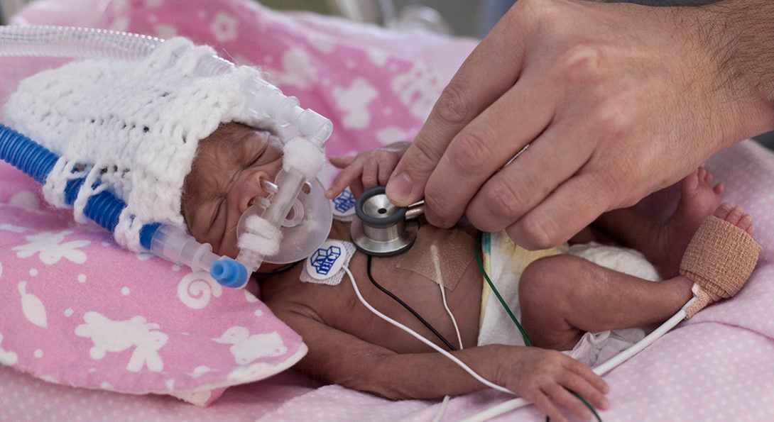 nurse checking the heartbeat of a premature baby