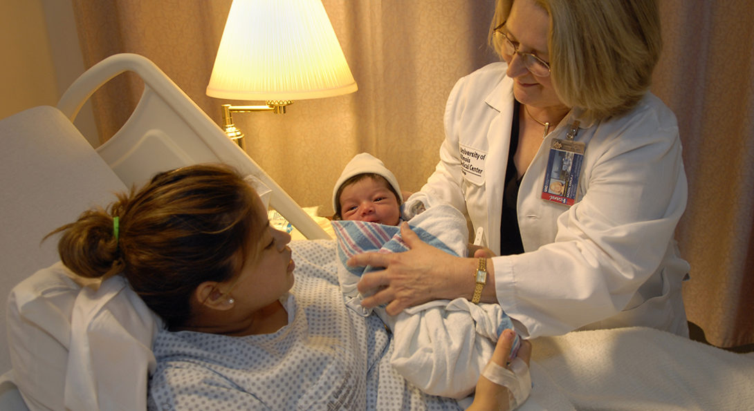nurse with mother and baby