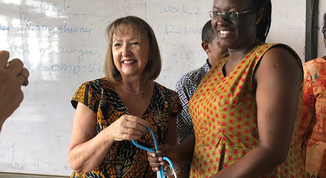 Holli DeVon delivering donated stethescopes to Rwandan nursing students