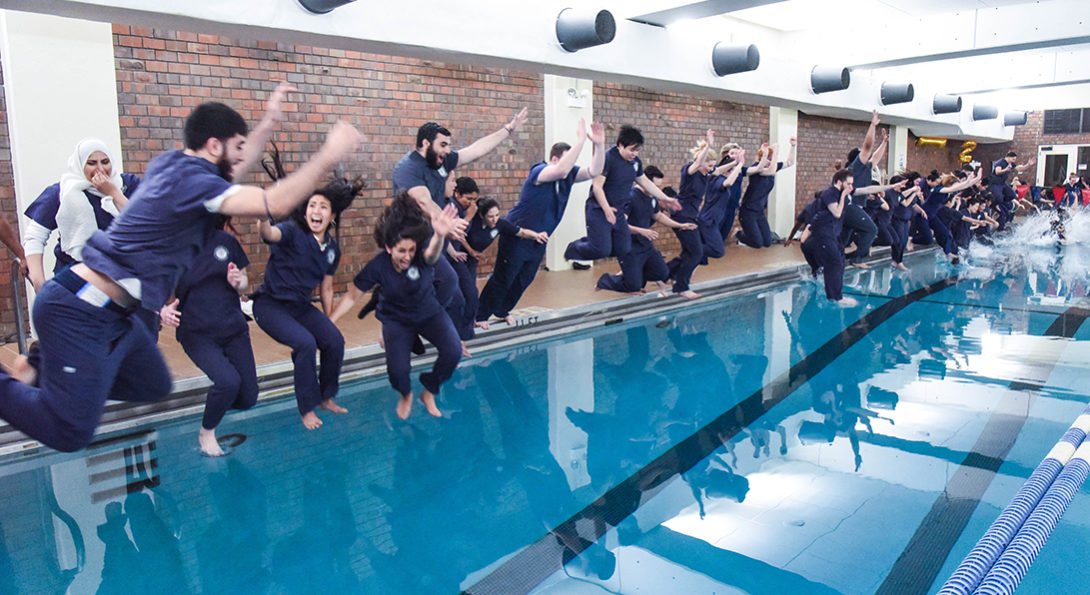 Students jump into pool