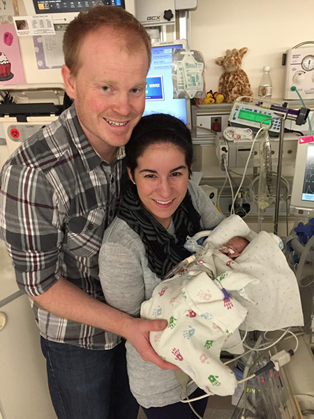 Tim Carroll and Rachel Caputo holding baby London at six weeks