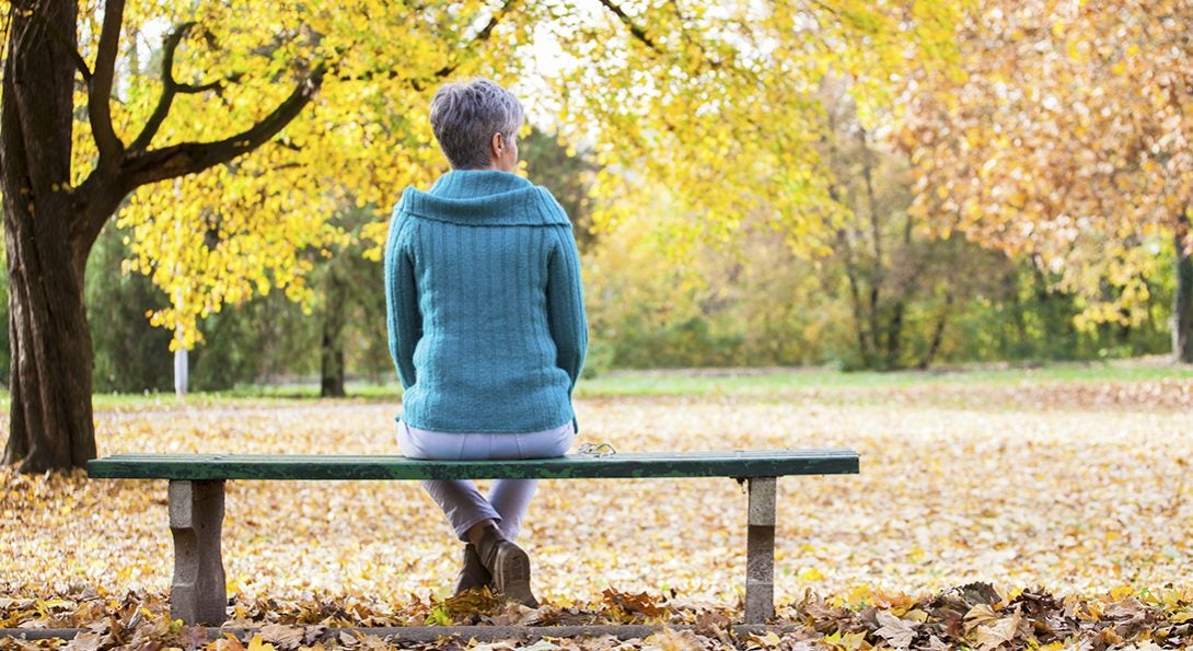 Woman alone on park bench