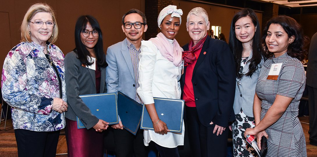 Associate deans Linda McCreary (far left) and Catherine Vincent (third from right) celebrate with international PhD students