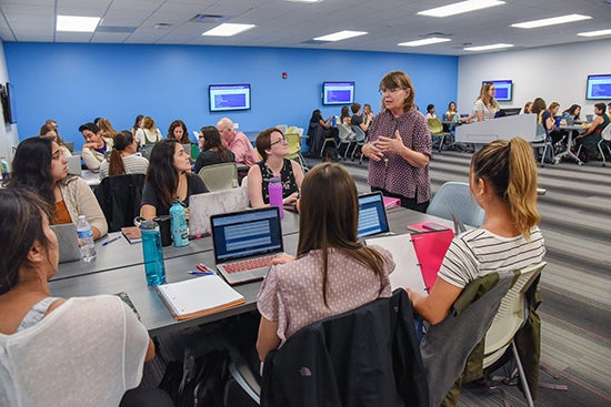 Students at group table with instructor