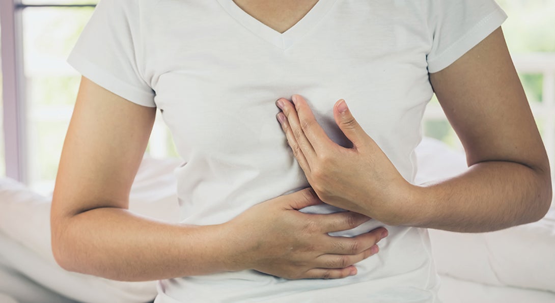 Person holding chest near heart