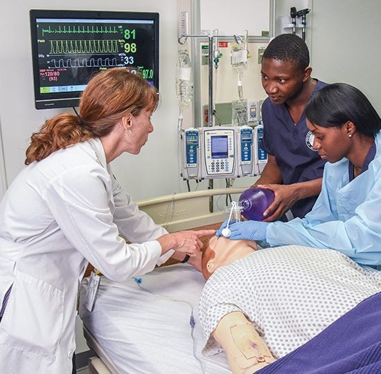 Group of UIC Nursing students smile while taking a picture.