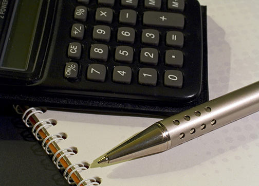 Calculator, pen and notebook