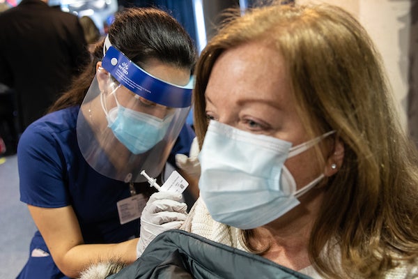 Nursing student Maria Escamilla administering a COVID-19 vaccination