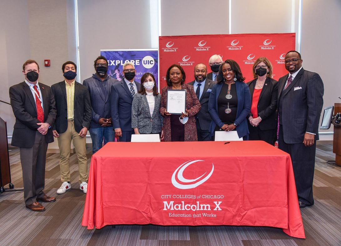 (l-r) Robert Barish, Vice Chancellor for Health Affairs, UI Health; Miguel Molina, Chief of Staff for State Rep. Maura Hirschauer; Cook County Commissioner Brandon Johnson; City Colleges of Chicago Chancellor Juan Salgado; Sevinj Kazimli, one of the first students to enter UIC under new agreement; State Rep. Mary Flowers; State Rep. Jawaharial Williams; UIC CHancellor Michael Amiridis; Tammy Scott-Brand, Dean of the Malcolm X College Nursing Program; Eileen Collins, Dean of the UIC College of Nursing; David Sanders, President of Malcolm X College.