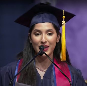 Class of 2022 student speaker Jasmine Medina, BSN '22, at the microphone during commencement the ceremony
                  