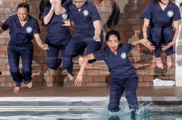 Students jump into a swimming pool