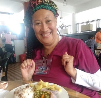 plate of food in front of smiling woman