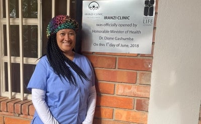 Nursing student in front of sign