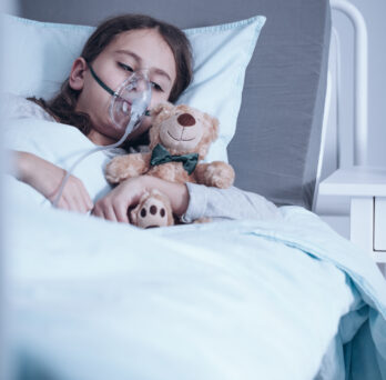 Child in hospital bed
                  