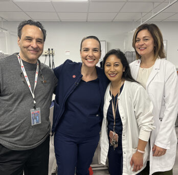 WGN reporter Ana Belaval poses with staff of the Schwartz Simulation Lab 