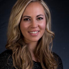 woman with long hair smiles at camera