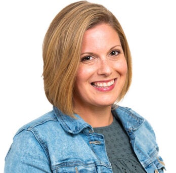 smiling woman wearing a jean jacket 