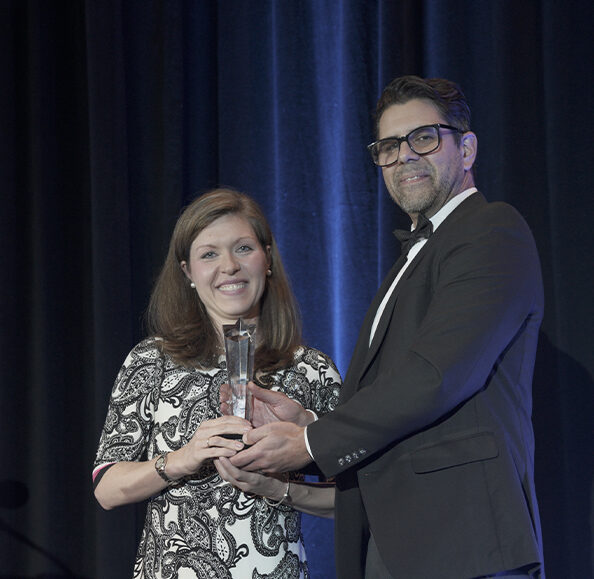 Woman accepting award from man