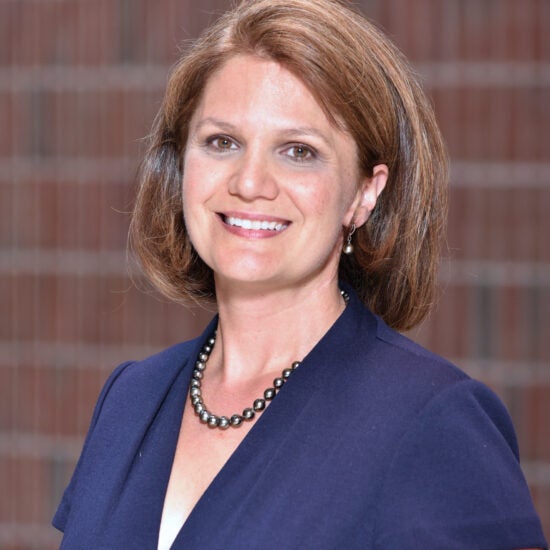 Woman in front of a brick wall