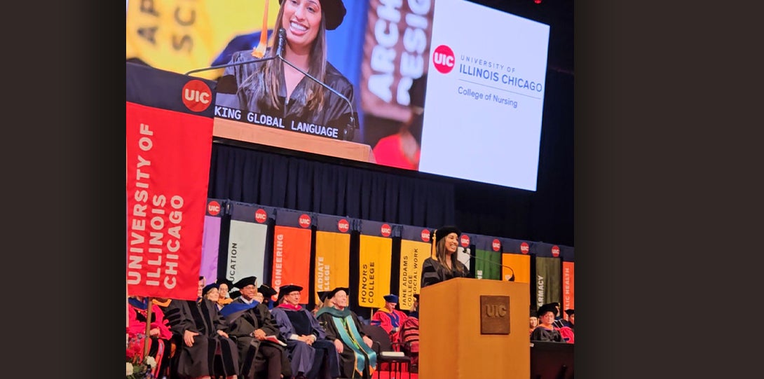 A woman stands behind a podium while delivering a speech