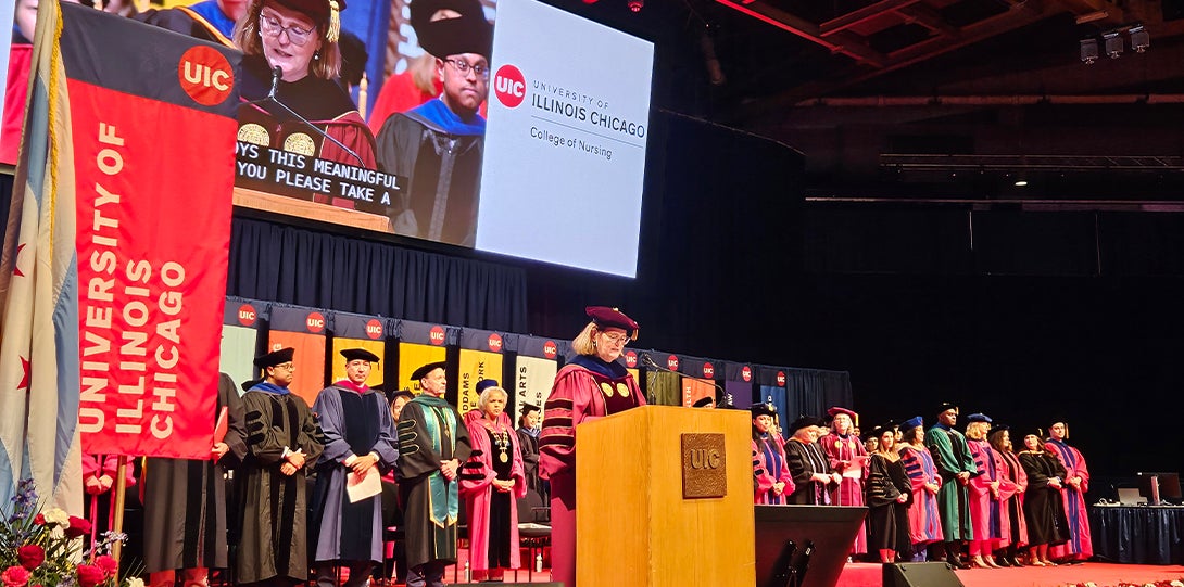 A woman stands behind a podium while delivering a speech