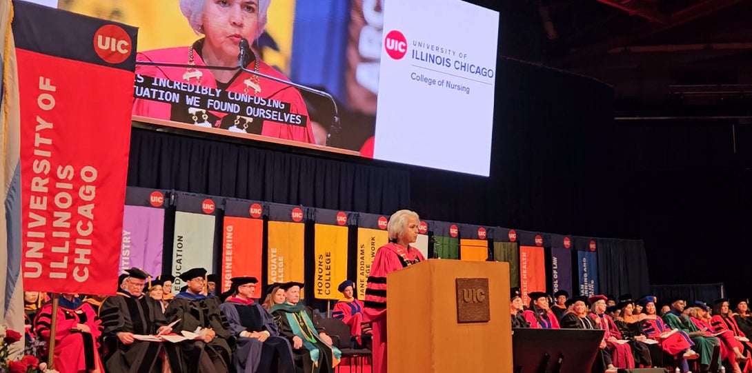 A woman stands behind a podium while delivering a speech