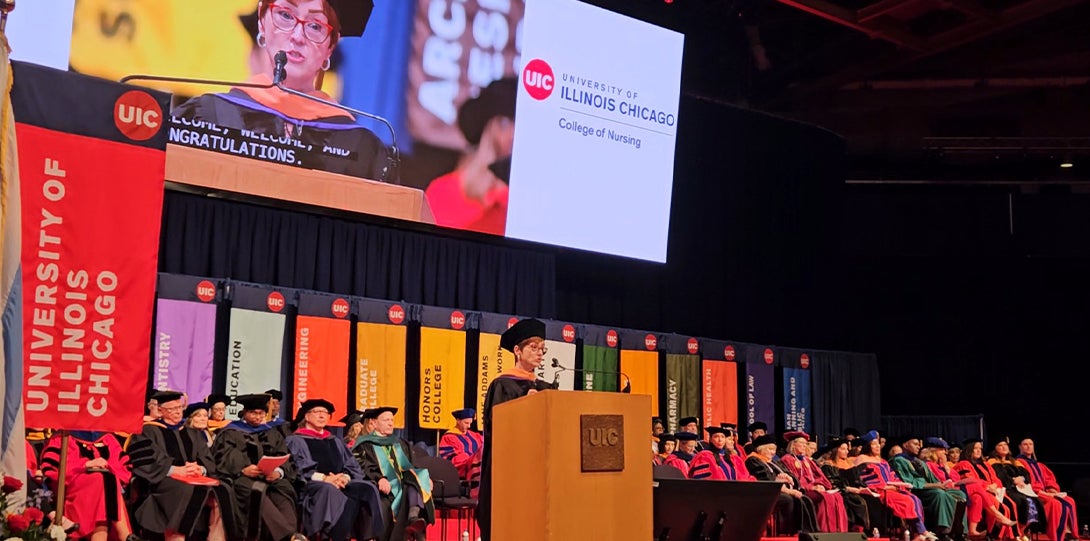 A women stands behind a podium while delivering a speech