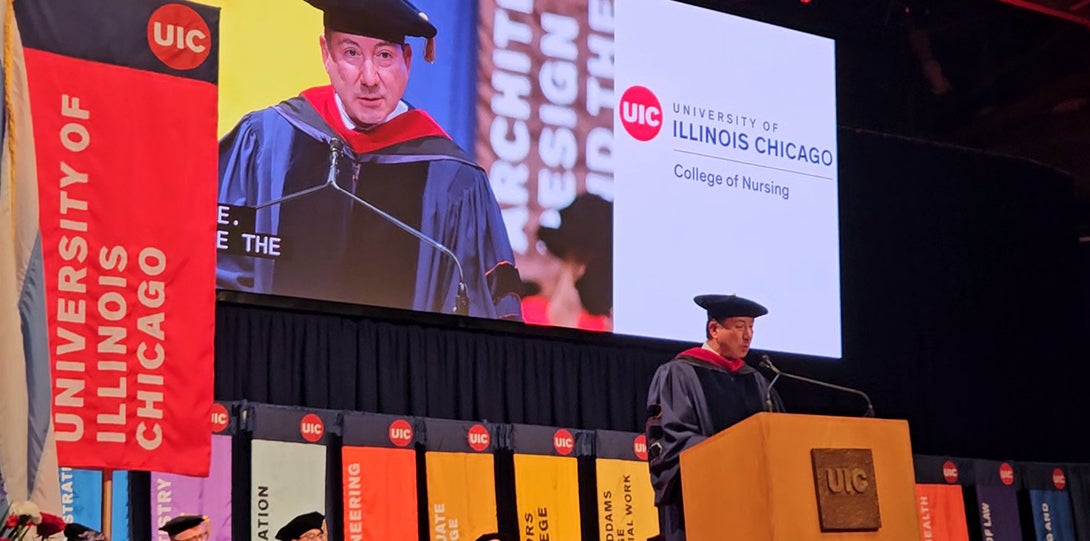 A man stands behind a podium while delivering a speech