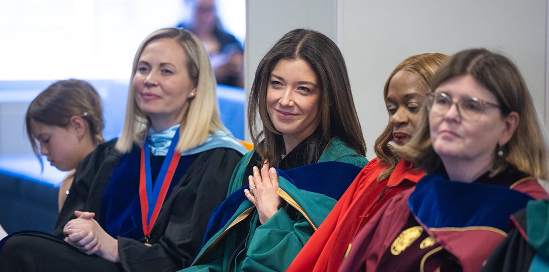 several women sit and listen to remarks