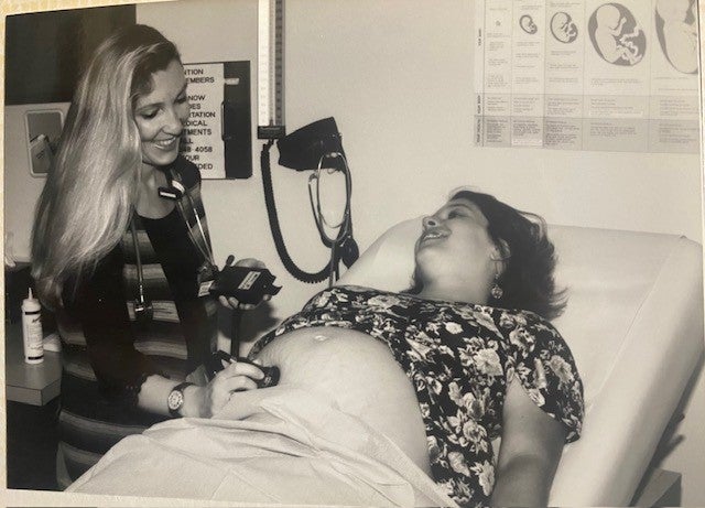 Katie Moriarty uses a stethoscope on a pregnant patient