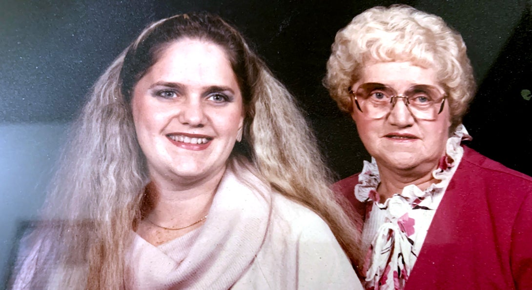 Daughter and mother pose for family portrait