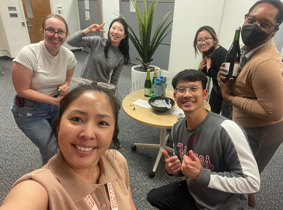 A diverse group of graduate students pose for a photograph