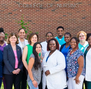 large group of nursing professionals pose for picture
                  