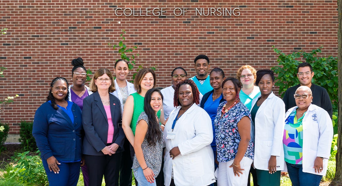 large group of nursing professionals pose for picture