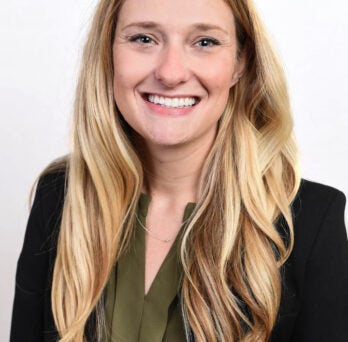 Woman with long blonde hair smiling at camera 